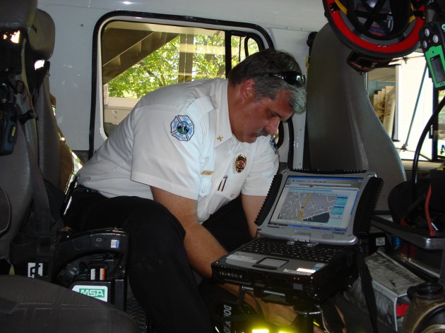 Chapel Hill Assistant Fire Marshall Dace Bergen on board a fire truck equipped with the RENCI-developed Automated Vehicle Location System.