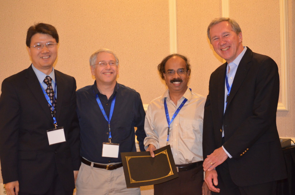 Paper authors (from right) Justin Zhan, Howard Lander, and Arcot Rajasekar with one of the conference's keynote speakers, Tom Mitchell of Carnegie Mellon's School of Computer Science.