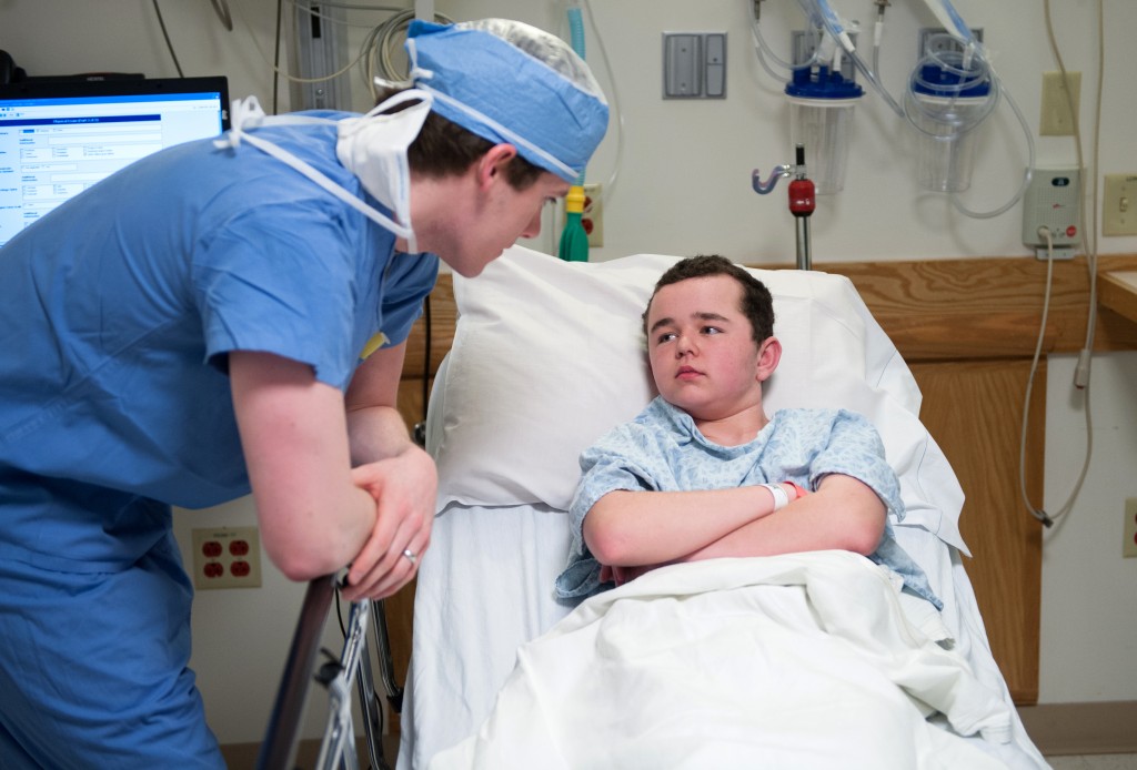 A doctor at Boston Children’s Hospital checks on a young epilepsy patient during treatment. Photo credit: Katherine C. Cohen, Boston Children’s Hospital